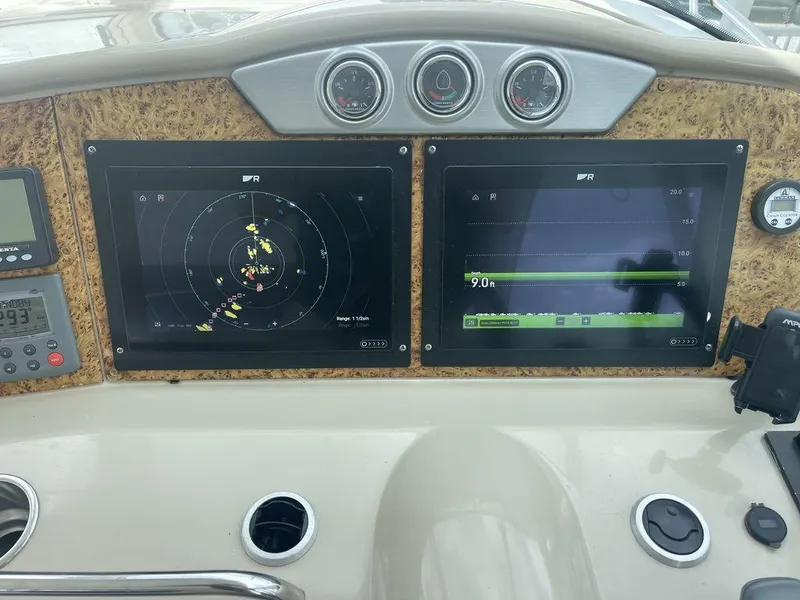 Slide: The Image of Dashboard of a 2009 Formula 45 Yacht with navigation and radar screens. - 7