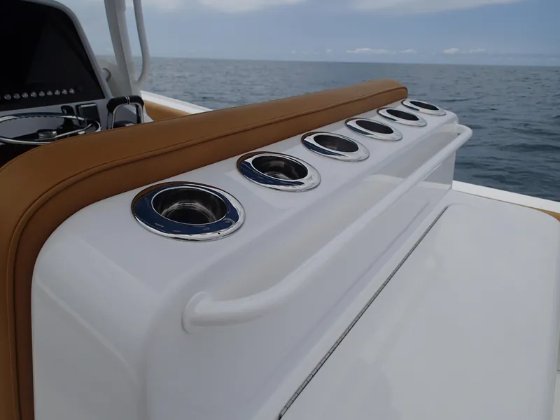 Slide: The Image of Mag Bay 33 CC 2025 boat with rod holders and ocean view. - 12