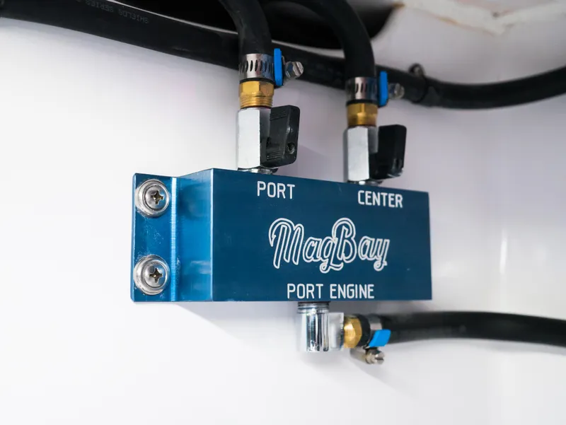 Slide: The Image of Mag Bay 33 CC 2025 port engine component with hoses and connectors. - 17