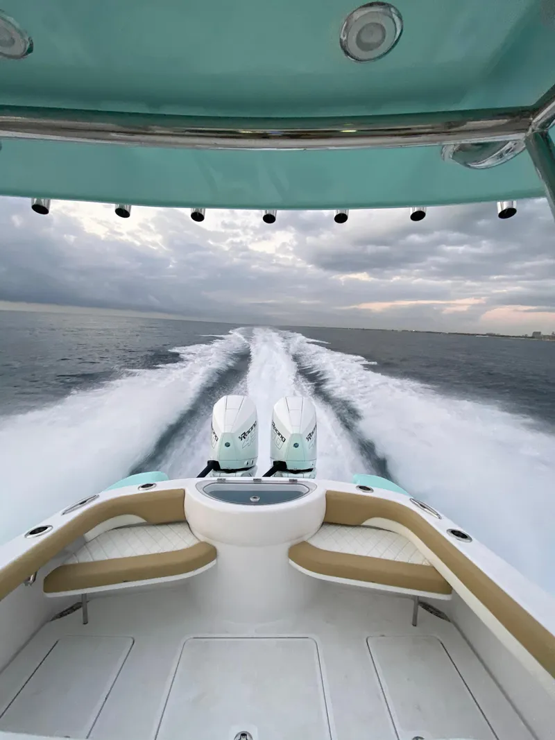 Slide: The Image of 2025 Mag Bay 33 CC boat with twin engines cruising on open water. - 6