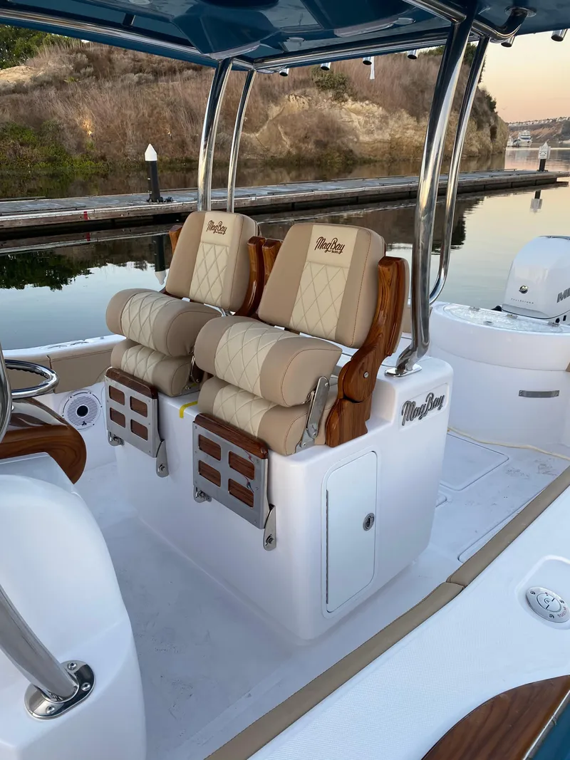 Slide: The Image of 2025 Mag Bay 33 CC boat with luxurious seating and sleek design. - 8