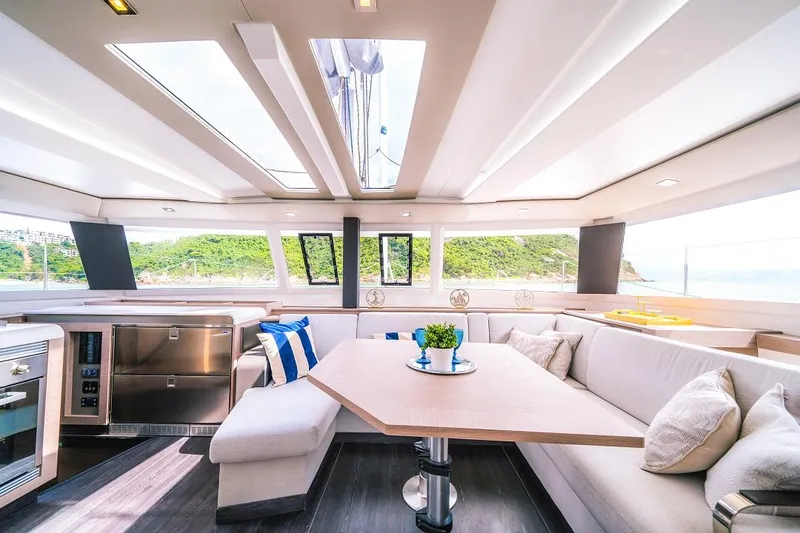 The Image of Luxurious interior of 2024 Fountaine Pajot Tanna 47 catamaran with modern furnishings and panoramic windows. - 0