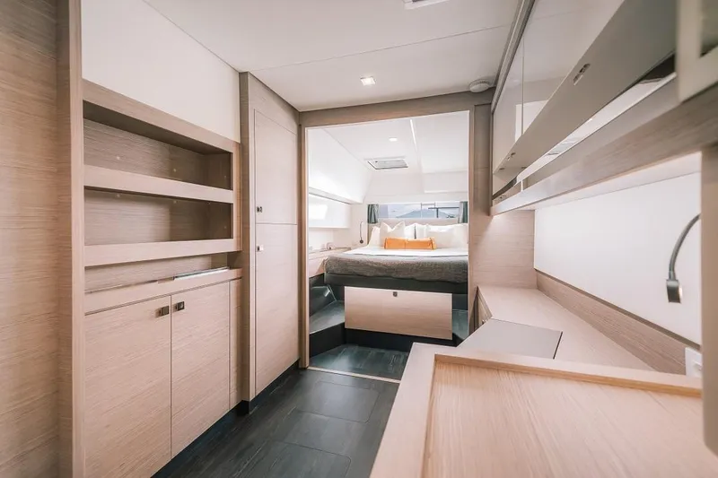 Slide: The Image of 2024 Fountaine Pajot Tanna 47 yacht interior bedroom with modern wooden furnishings. - 4