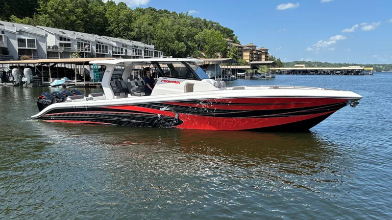 The Image of 2024 Fountain 43 SCX boat on a lake, featuring sleek red and black design. - 1