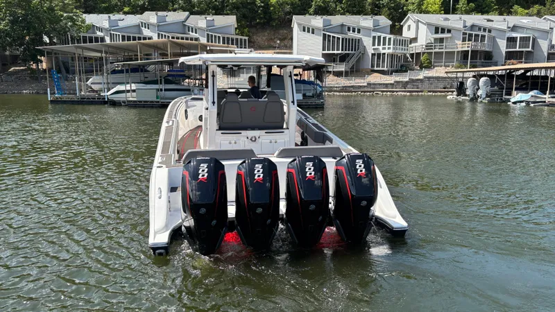 Slide: The Image of 2024 Fountain 43 SCX boat with four powerful outboard motors on a lake. - 11