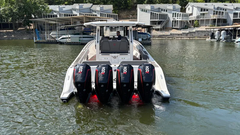 Slide: The Image of 2024 Fountain 43 SCX boat with four powerful outboard motors on a calm lake. - 12