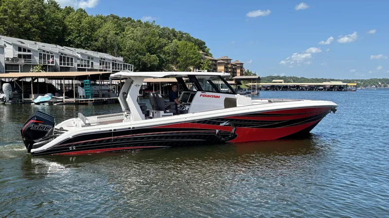 Slide: The Image of 2024 Fountain 43 SCX boat on a lake, featuring sleek red and black design. - 13