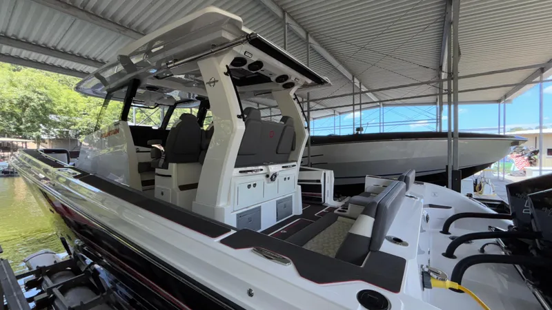 Slide: The Image of 2024 Fountain 43 SCX boat docked under a metal canopy. - 15