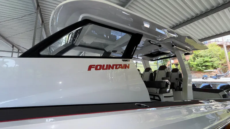 Slide: The Image of 2024 Fountain 43 SCX boat under a metal canopy, showcasing sleek design and seating. - 17