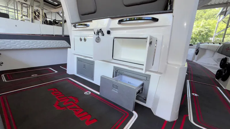 Slide: The Image of 2024 Fountain 43 SCX boat interior with storage compartments and branded flooring. - 27