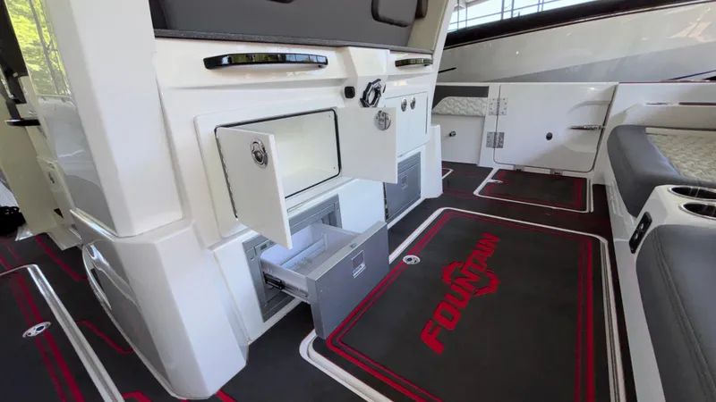 Slide: The Image of 2024 Fountain 43 SCX boat interior with open storage compartments and branded flooring. - 28