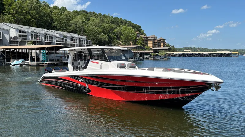 Slide: The Image of 2024 Fountain 43 SCX boat on a lake, featuring sleek red and black design. - 3