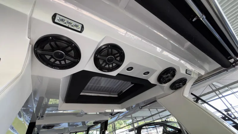 Slide: The Image of 2024 Fountain 43 SCX boat interior with speakers and lighting under a canopy. - 34