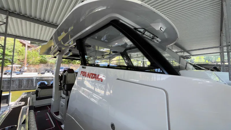 Slide: The Image of 2024 Fountain 43 SCX boat under a covered dock, showcasing sleek design and modern features. - 35
