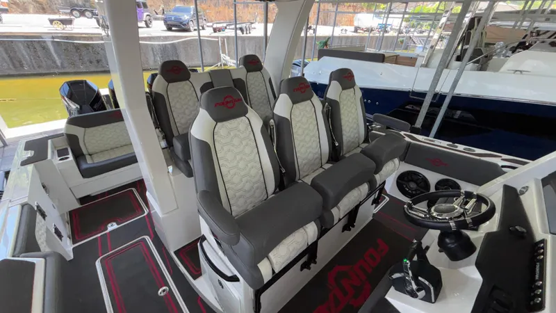 Slide: The Image of 2024 Fountain 43 SCX boat interior with luxurious seating and modern steering console. - 38