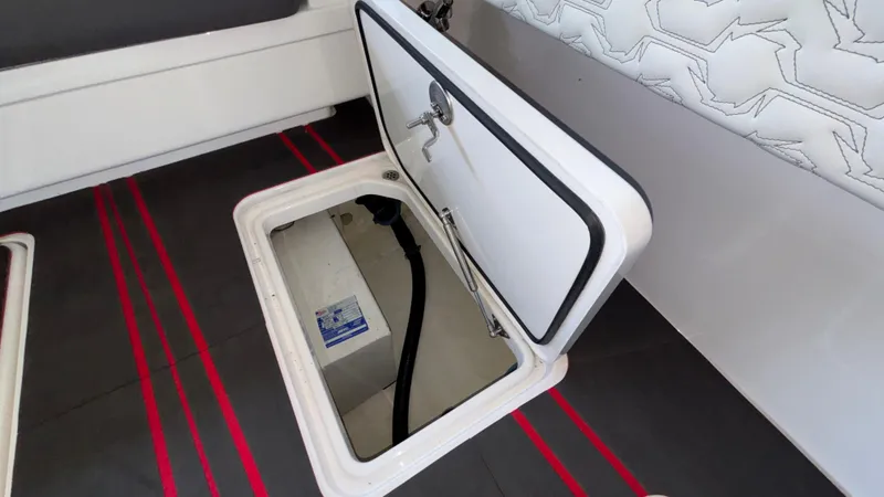 Slide: The Image of Open storage compartment on 2024 Fountain 43 SCX boat, featuring sleek interior design. - 46