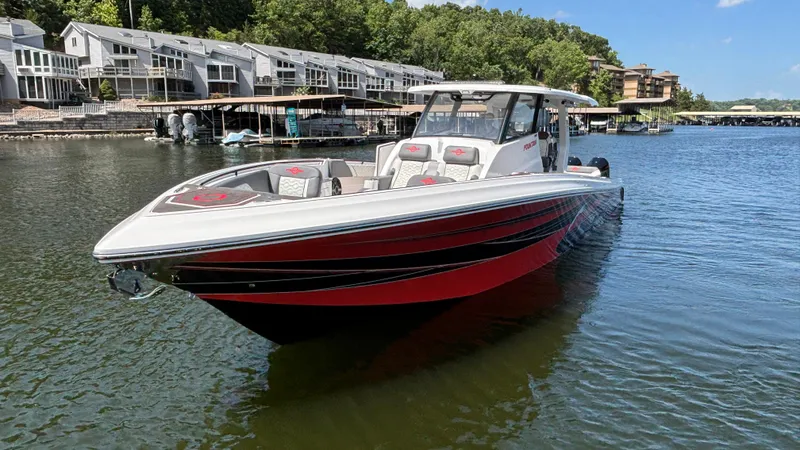 Slide: The Image of 2024 Fountain 43 SCX boat on a lake near waterfront homes. - 5