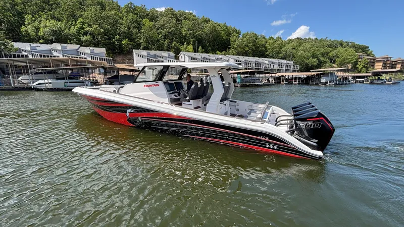 Slide: The Image of 2024 Fountain 43 SCX boat on a lake, surrounded by docks and trees. - 8