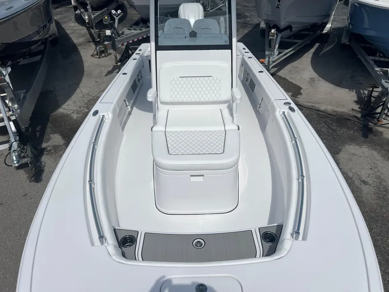 Slide: The Image of 2024 Sportsman 247 OE boat, front deck view with seating and storage. - 10