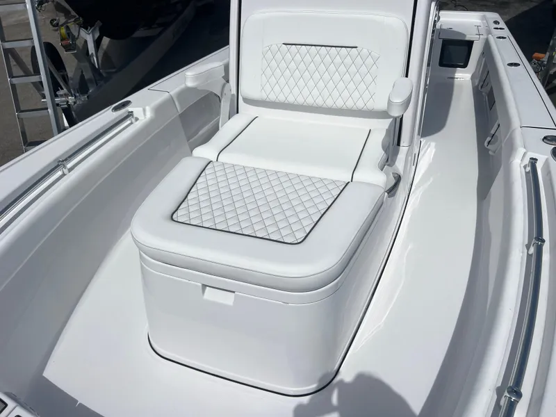 Slide: The Image of 2024 Sportsman 247 OE boat with white cushioned seating. - 11
