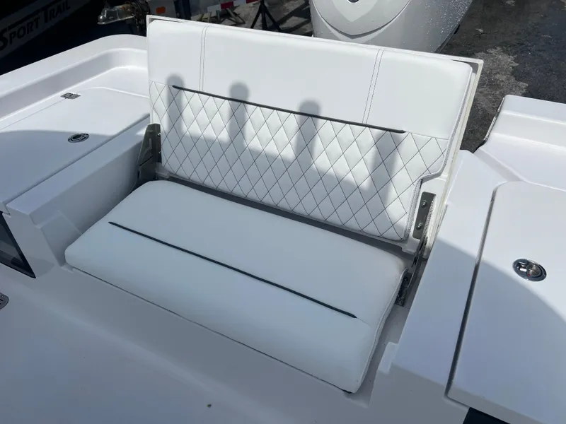 Slide: The Image of 2024 Sportsman 247 OE boat with white cushioned seating. - 14