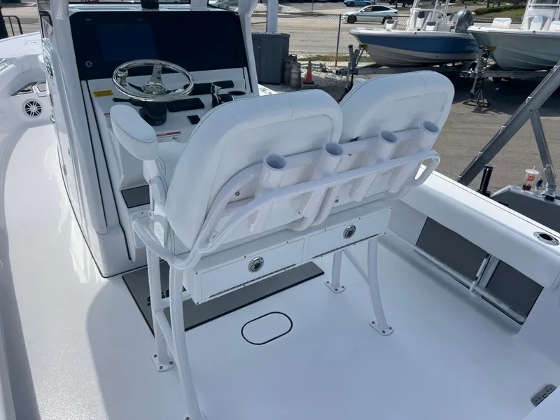 Slide: The Image of 2024 Sportsman 247 OE boat interior with dual white captain's chairs and control console. - 6