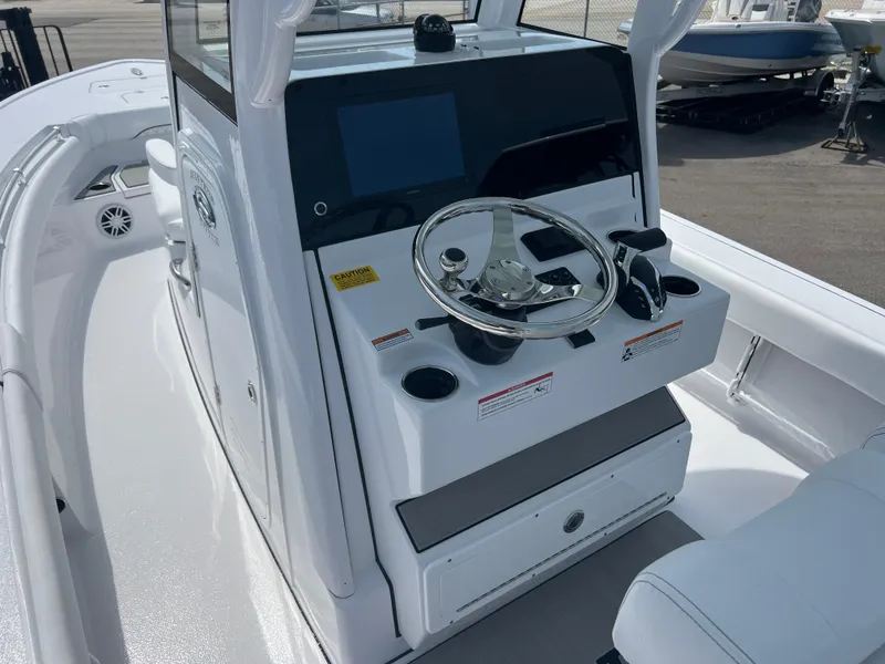 Slide: The Image of 2024 Sportsman 247 OE boat console with steering wheel and navigation screen. - 7