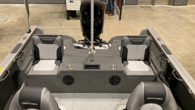 Slide: The Image of 2023 Crestliner 1750 Super Hawk boat interior with seating and motor. - 4