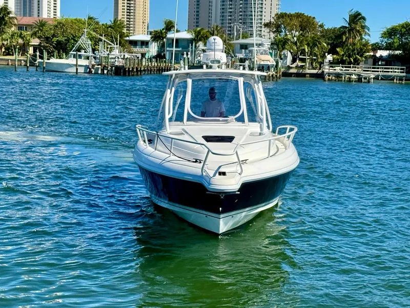 Slide: The Image of 2007 Intrepid 350 Walkaround boat cruising on a sunny day near a marina. - 38
