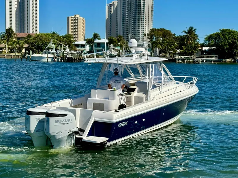 Slide: The Image of 2007 Intrepid 350 Walkaround boat cruising in a sunny waterfront city. - 42
