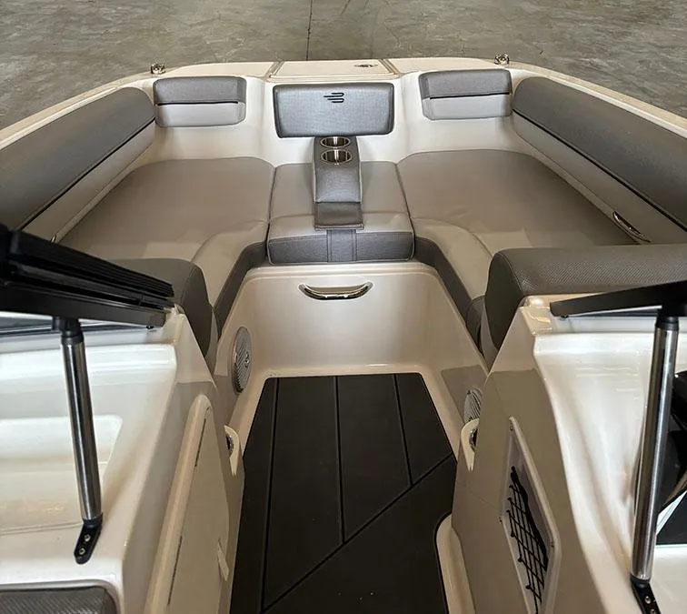 Slide: The Image of Interior seating of 2024 Bayliner DX2000 boat with gray cushions and cup holders. - 12