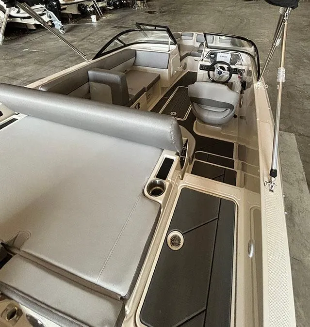 Slide: The Image of 2024 Bayliner DX2000 boat interior with seating and steering console. - 5