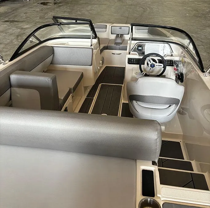 Slide: The Image of 2024 Bayliner DX2000 boat interior with modern seating and steering console. - 6
