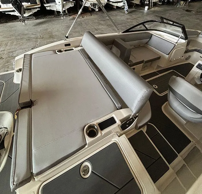 Slide: The Image of 2024 Bayliner DX2000 boat interior with gray seating and cup holders. - 7