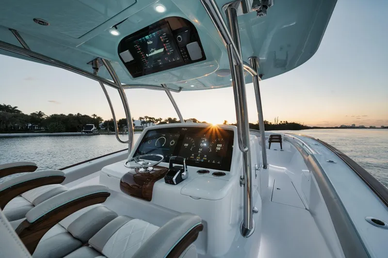 Slide: The Image of 2025 Mag Bay 43 CC boat interior with advanced navigation system at sunset. - 14