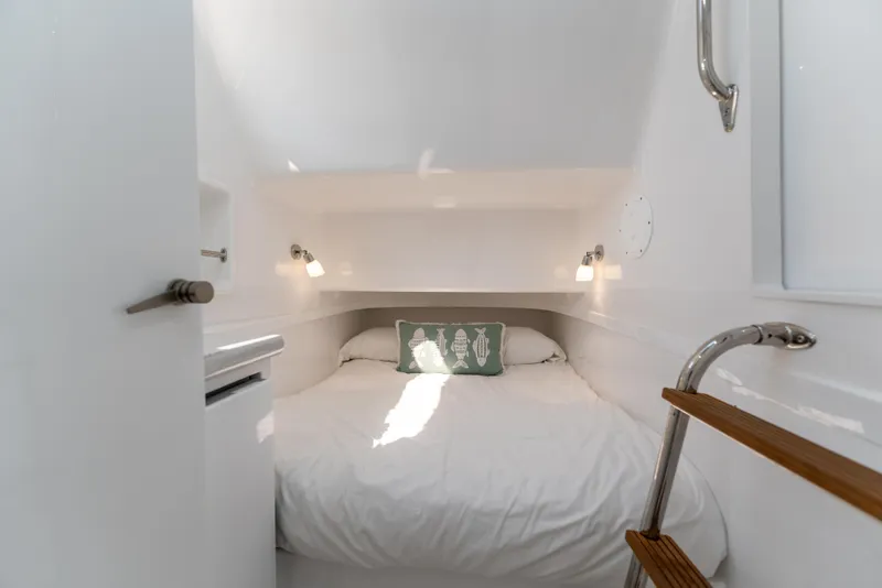 Slide: The Image of 2025 Mag Bay 43 CC cabin interior with cozy bed and modern lighting. - 24