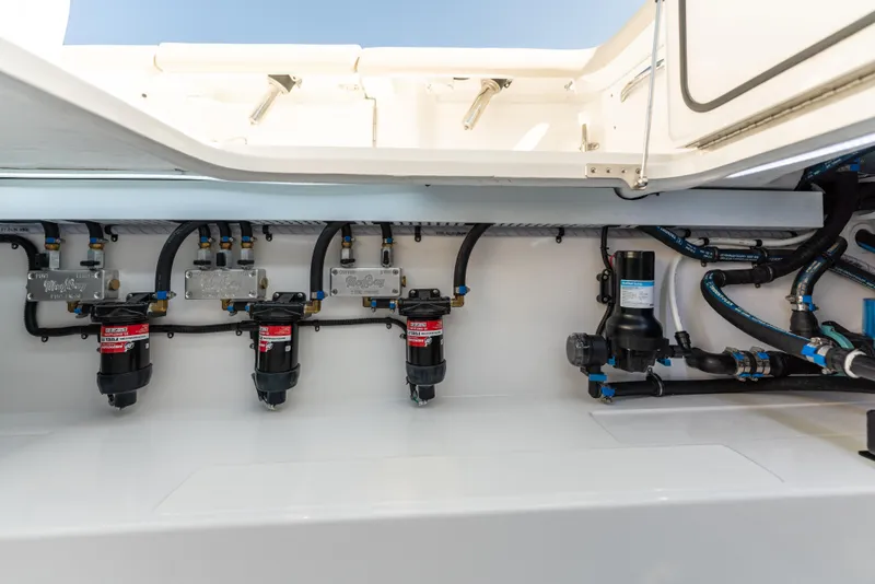 Slide: The Image of 2025 Mag Bay 43 CC boat engine compartment with fuel filters and hoses. - 29