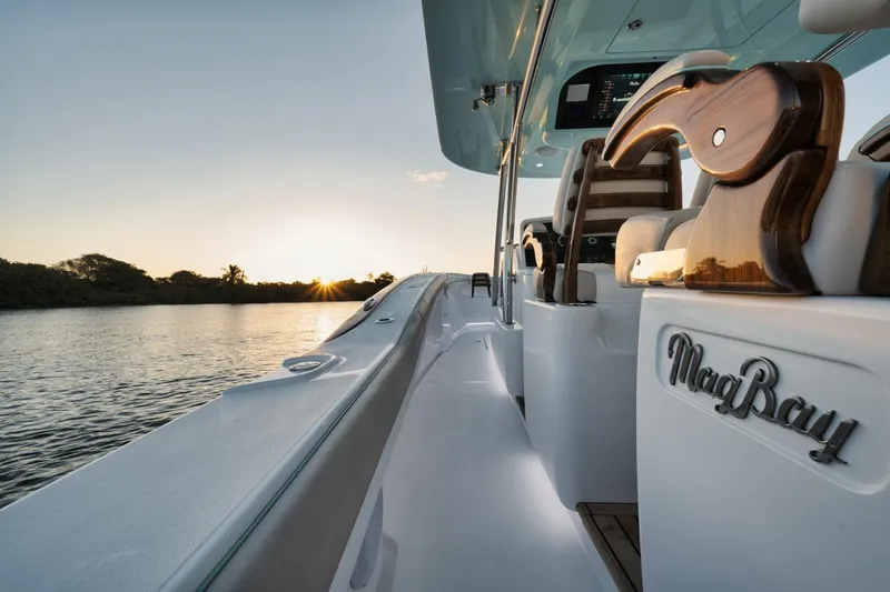 Slide: The Image of 2025 Mag Bay 43 CC boat at sunset on the water. - 9