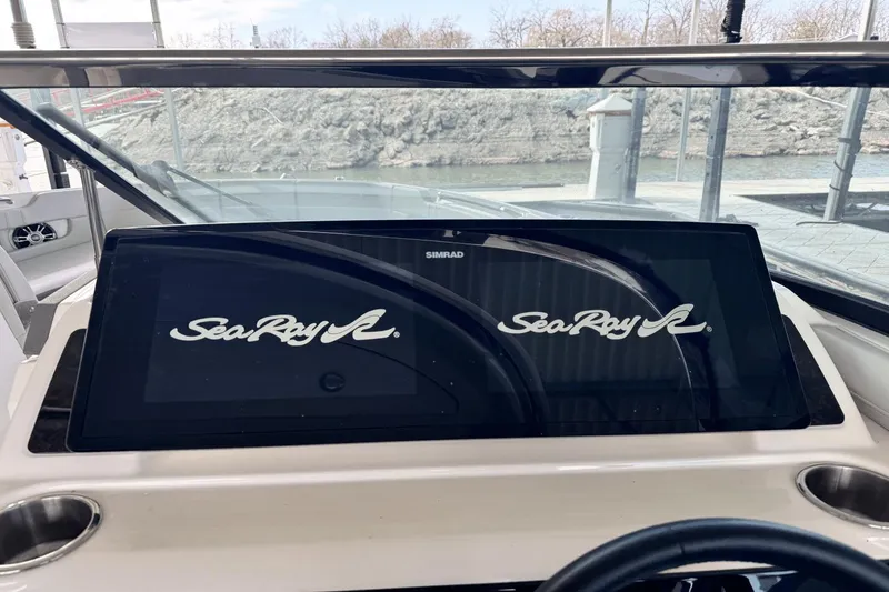 Slide: The Image of Dashboard of 2021 Sea Ray 310 SLX boat with Simrad display and Sea Ray logo. - 10