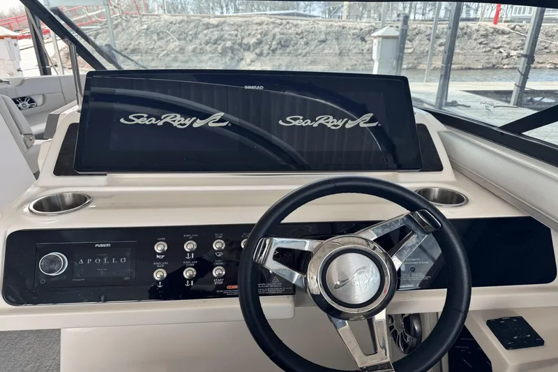 Slide: The Image of 2021 Sea Ray 310 SLX dashboard with steering wheel and control panel. - 11
