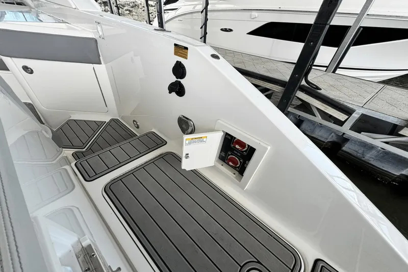 Slide: The Image of 2021 Sea Ray 310 SLX boat interior with control panel and non-slip flooring. - 18