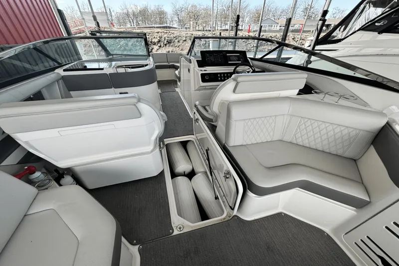 Slide: The Image of Interior of 2021 Sea Ray 310 SLX boat with luxurious seating and storage compartments. - 21