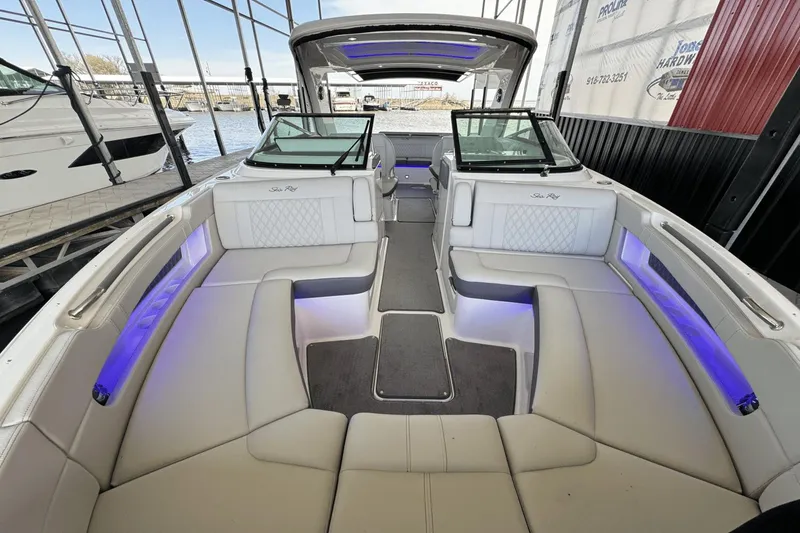 Slide: The Image of 2021 Sea Ray 310 SLX boat interior with luxurious seating and ambient lighting. - 26
