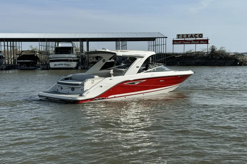 Slide: The Image of 2021 Sea Ray 310 SLX boat in water near dock with Texaco sign. - 3