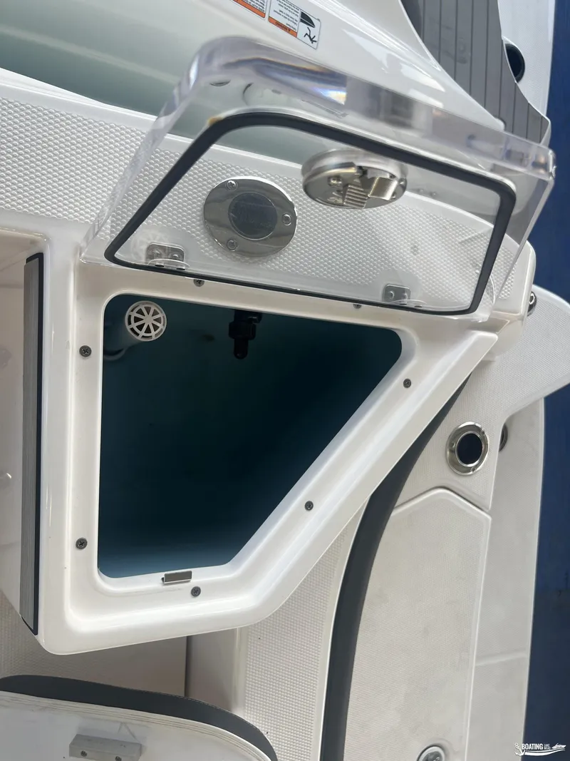 Slide: The Image of 2024 Yamaha Boats 222 FSH Sport storage compartment with open hatch. - 10