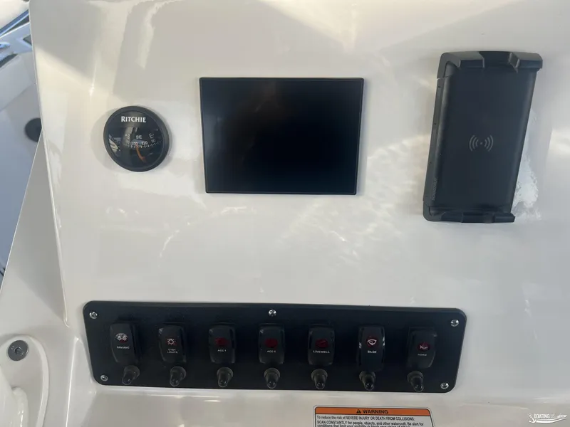 Slide: The Image of 2024 Yamaha Boats 222 FSH Sport dashboard with compass, screen, and control switches. - 12