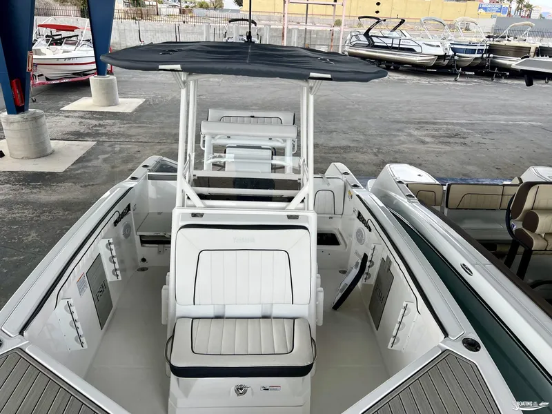 Slide: The Image of 2024 Yamaha Boats 222 FSH Sport, white interior, docked among other boats. - 4