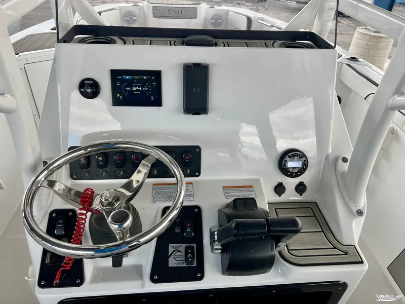Slide: The Image of 2024 Yamaha Boats 222 FSH Sport dashboard with steering wheel and control panel. - 5