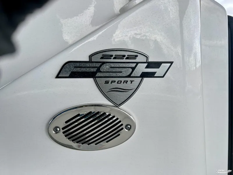 Slide: The Image of 2024 Yamaha Boats 222 FSH Sport logo on white boat exterior. - 7