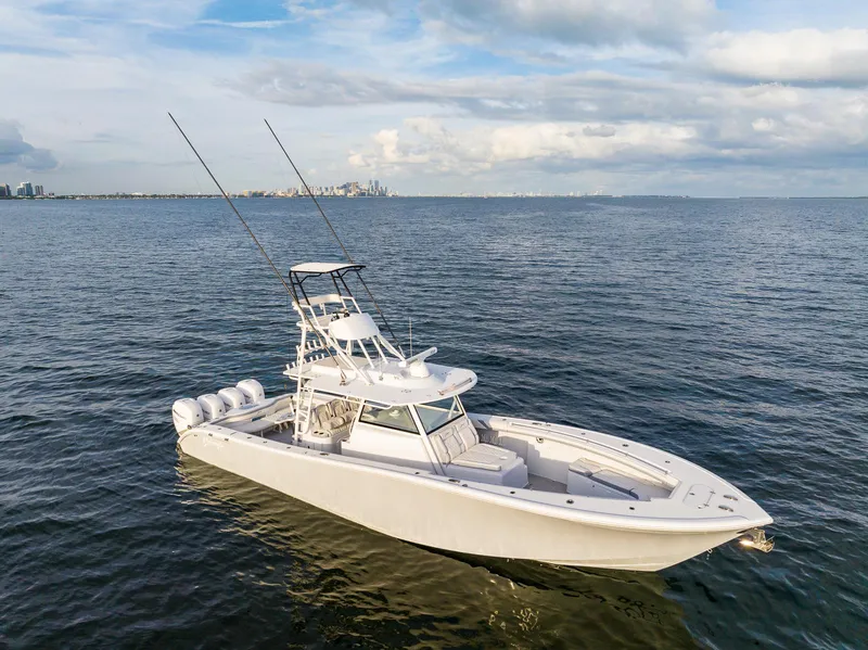 Slide: The Image of 2022 Yellowfin 42 boat on open water with city skyline in background. - 1